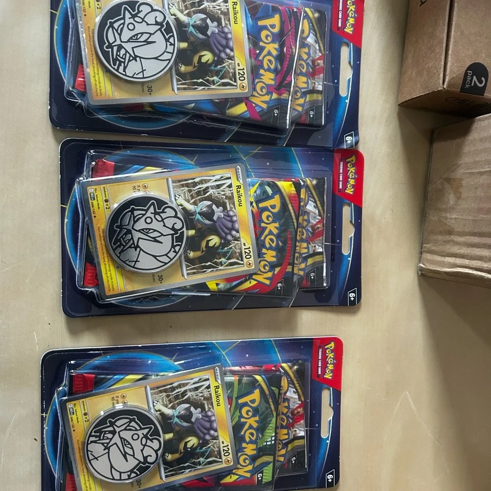 Lot of 10 Pokémon TCG booster double pack with two packs inside featuring Raikou